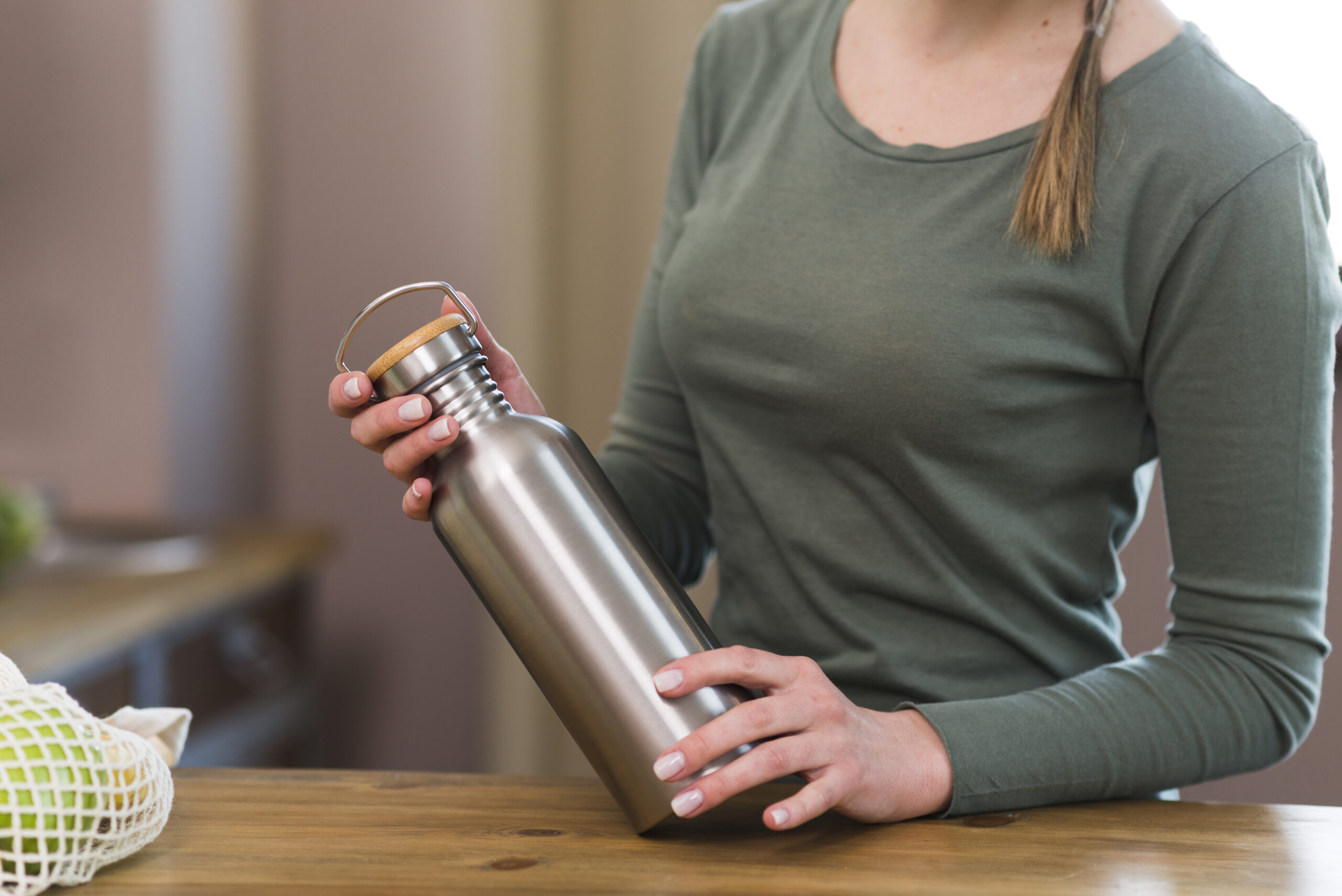 https://www.swellwaterbottlesale.com/wp-content/uploads/2023/08/close-up-woman-holding-coffee-thermos-scaled.jpg